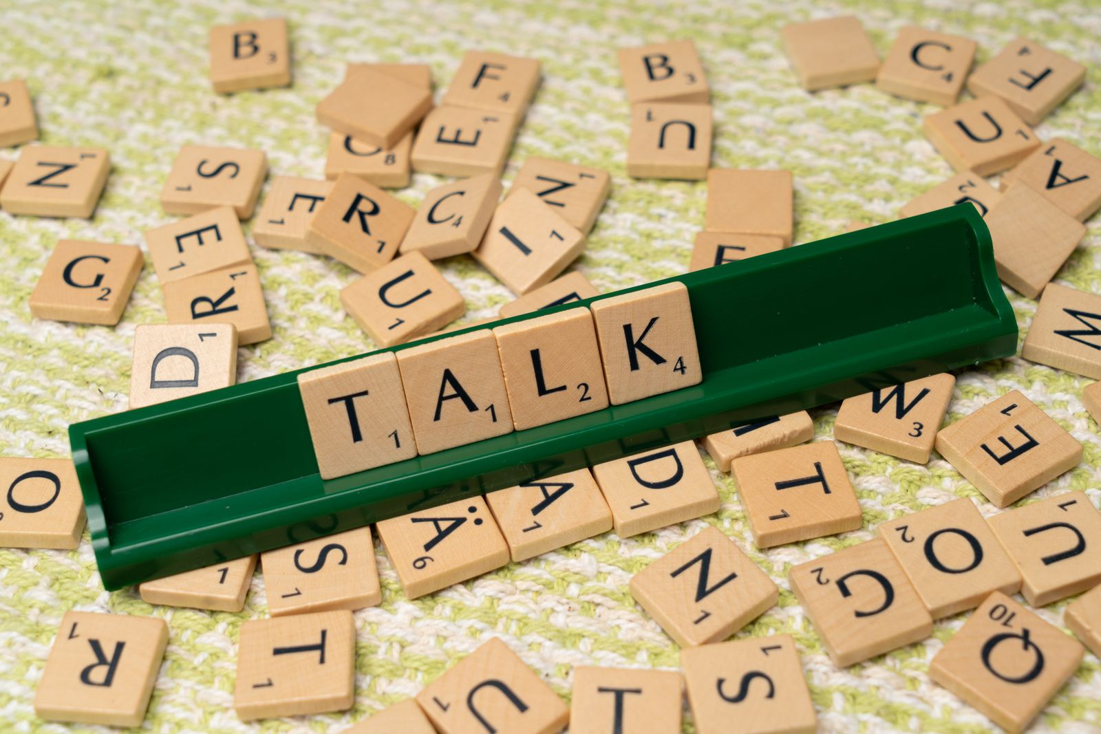 Scrabble tiles spelling out the word TALK — speech and language evaluation theme